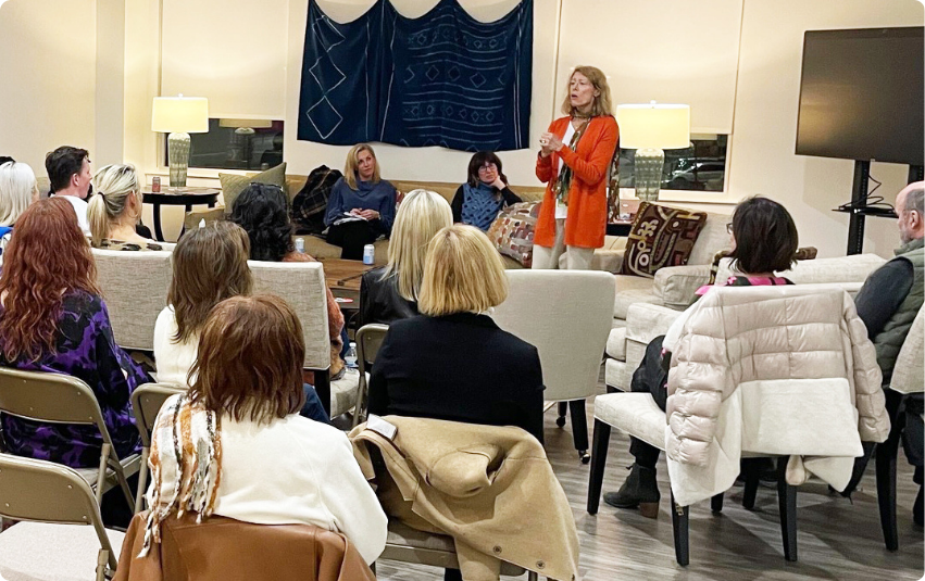 Color photo of an educational workshop in the comfortable living room at Gilda's West.