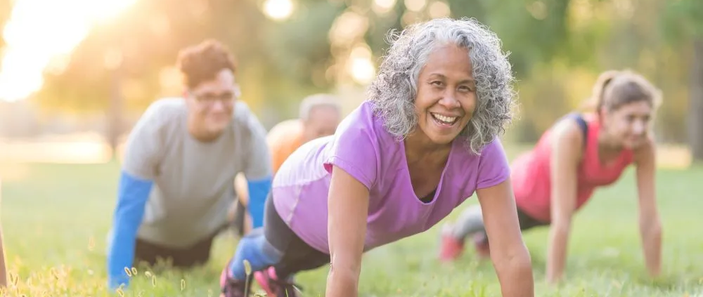 women doing push ups outdoors