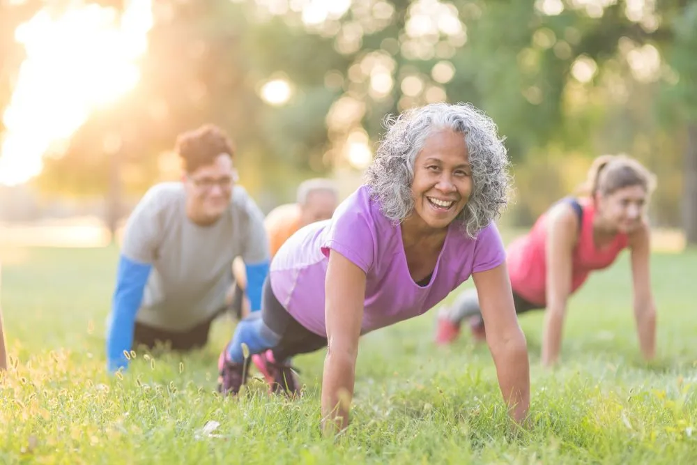 women doing push ups outdoors