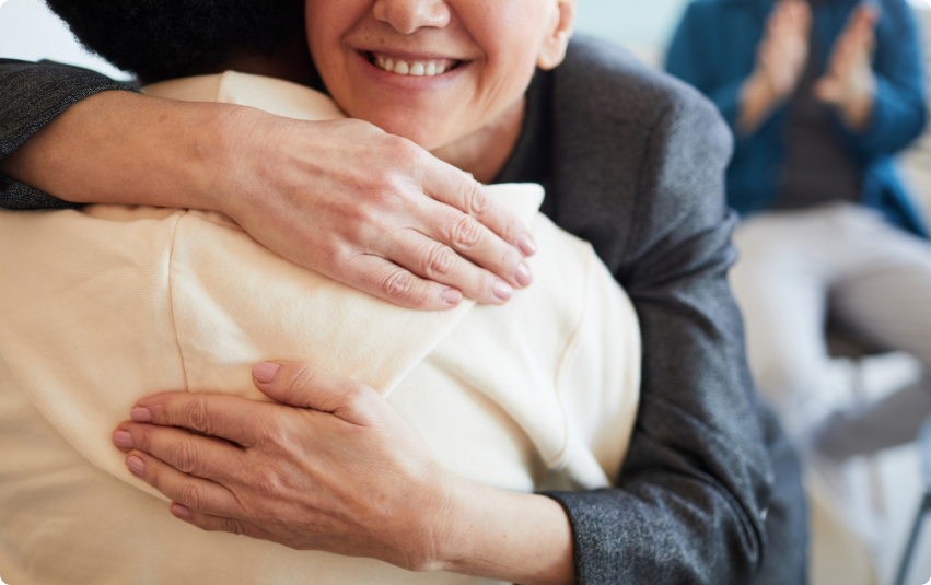 Close up photo of people hugging in free cancer support groups